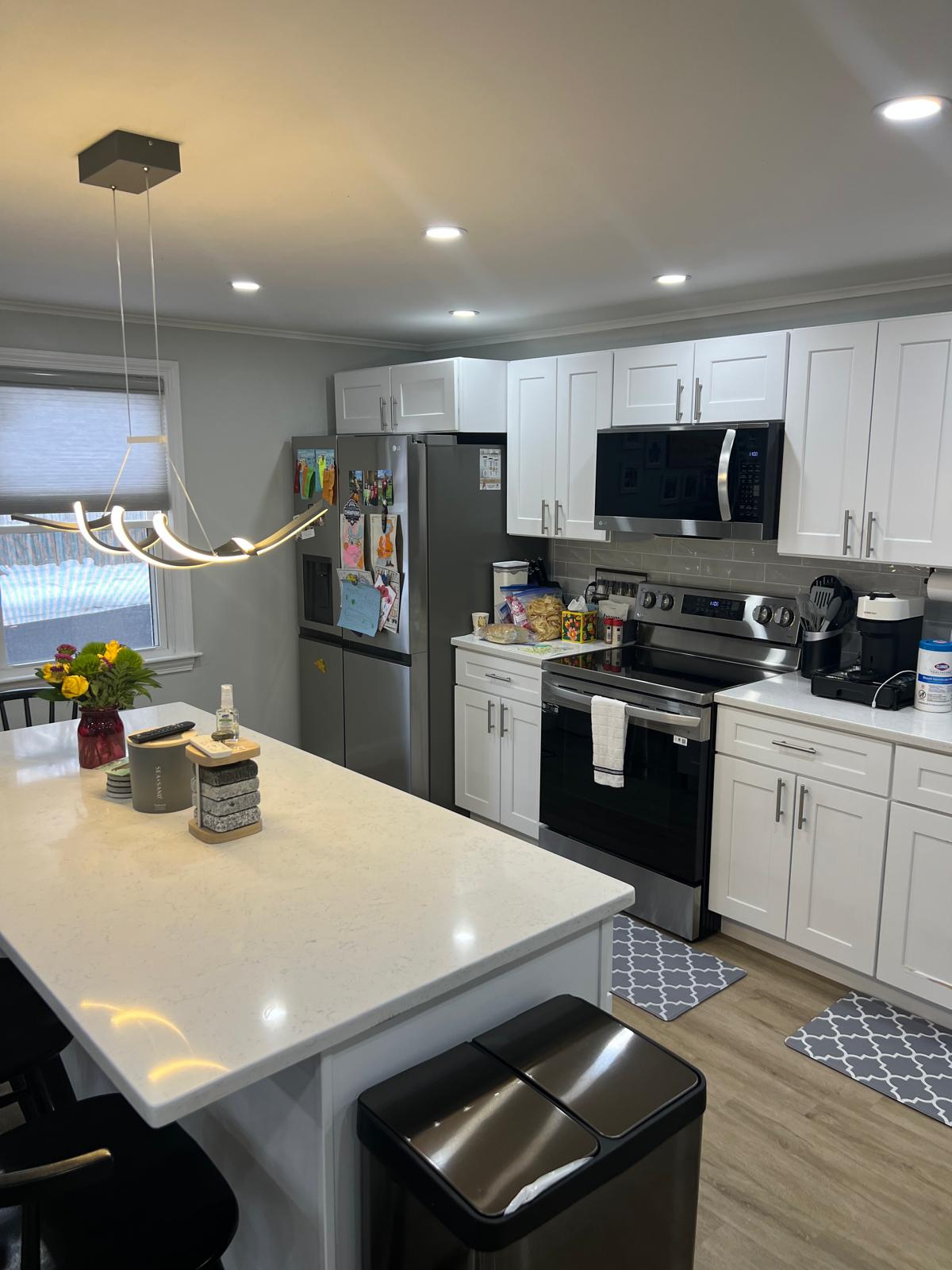 Clean stovetop, subway tile backsplash and granite counters
